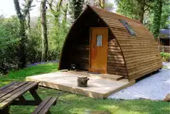 Wooden camping pod with a picnic bench