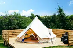 Bell tents on decking areas with outdoor seating