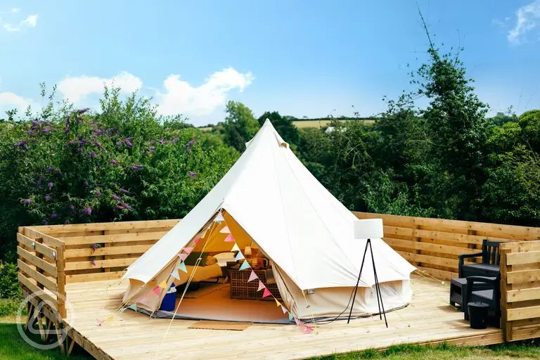 Bell tents on decking areas with outdoor seating