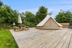 Bell tent on a private deck with outdoor seating