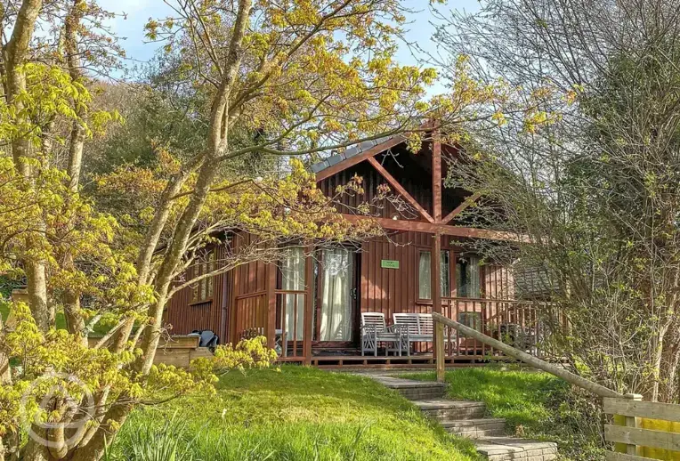 Lodge with an outdoor deck and hot tub