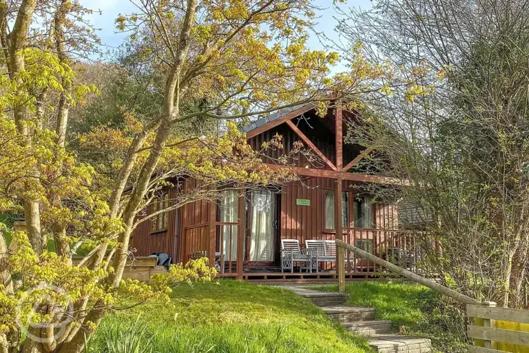 Lodge with an outdoor deck and hot tub