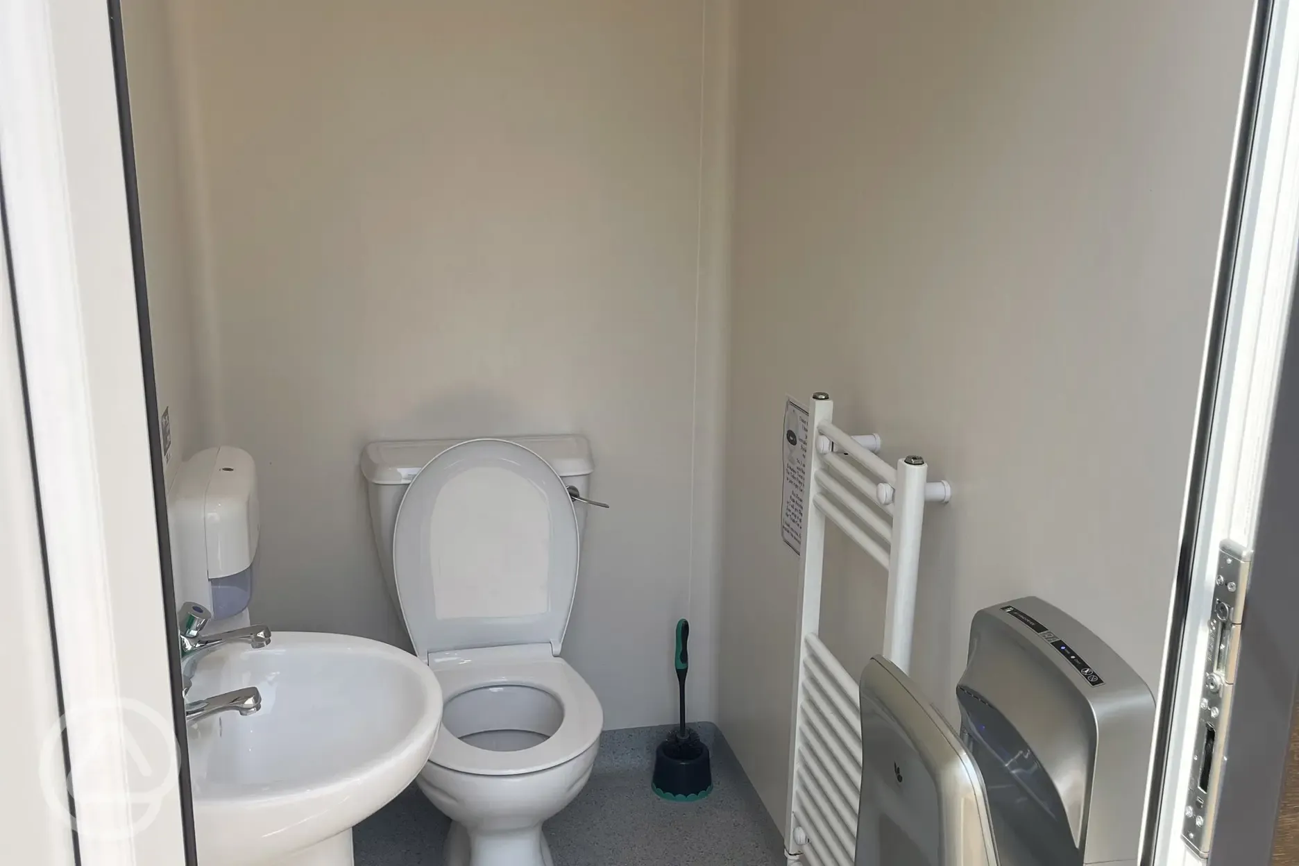 Toilet with towel rail and hand dryer