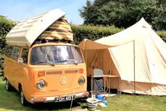 Campervan and bell tent on an electric grass pitch Campervan and bell tent on an electric grass pitch