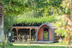 Large camping pods with outdoor furniture and a deck area