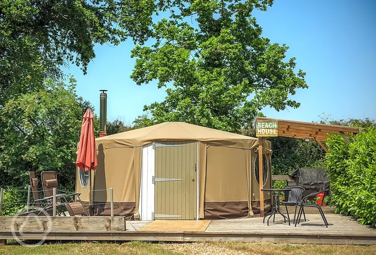 Beach yurt with a decking area and parasol