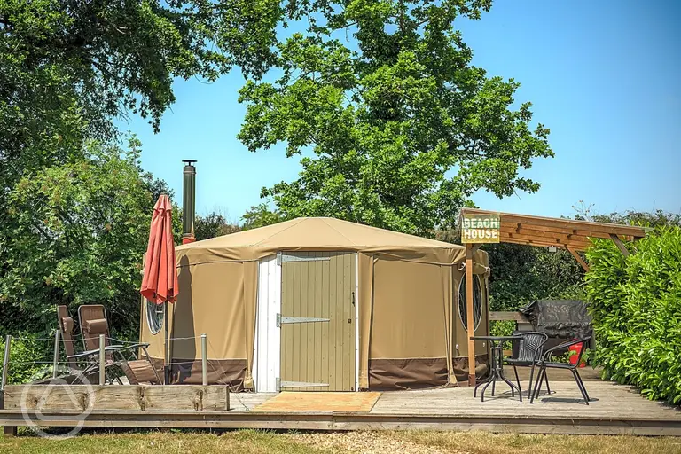Beach yurt with a decking area and parasol