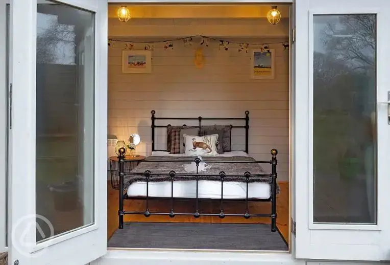 Lodge pod with a double bed and double doors