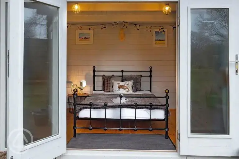 Lodge pod with a double bed and double doors