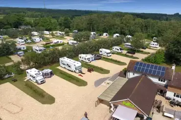 Aerial of the hardstanding touring pitches with small hedges between
