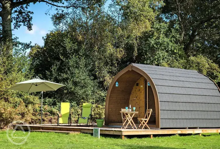 Large camping pods with outdoor furniture and a deck area