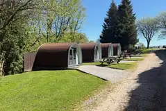 Camping pods with outdoor picnic benches