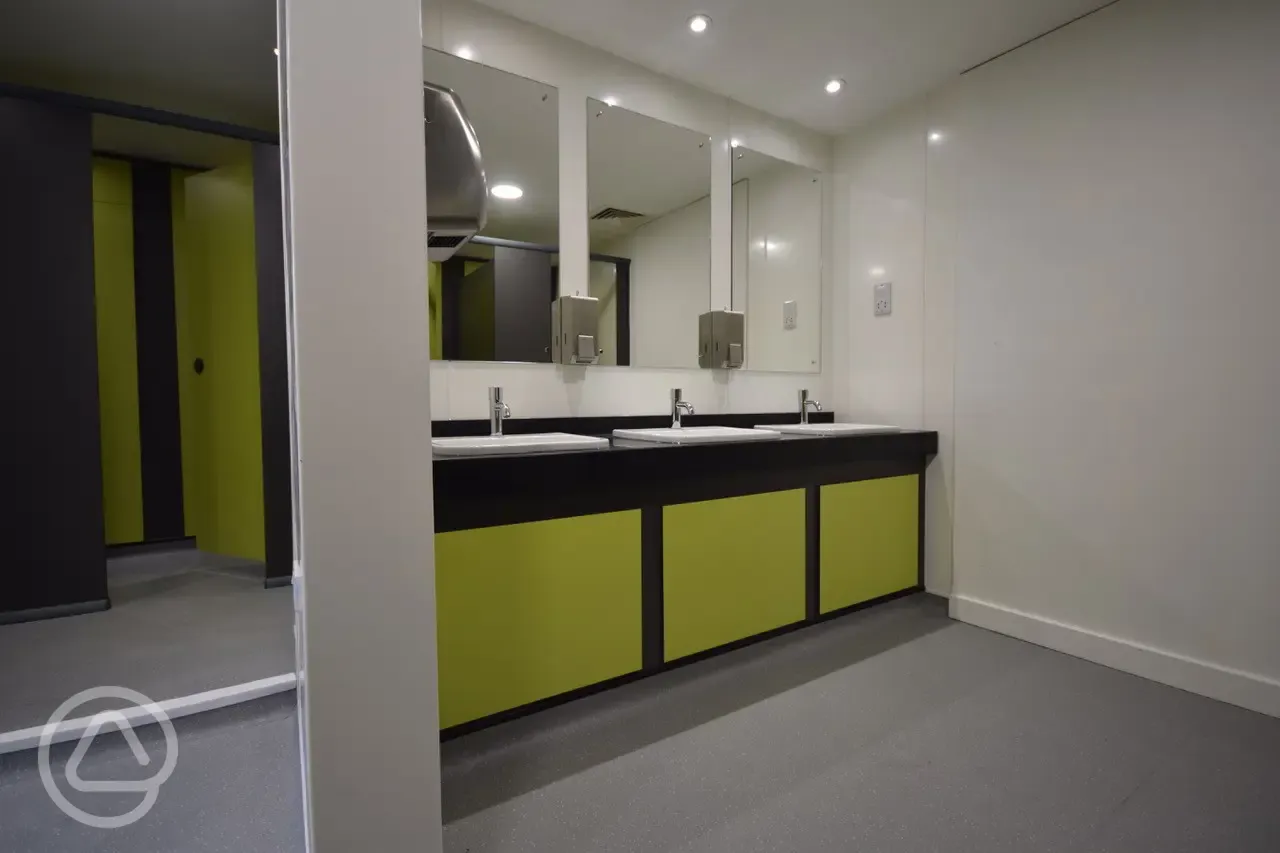 Wash basins and mirrors with hand dryers