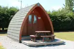 Standard unfurnished pod with outdoor decking and seating area