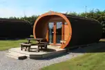 Super deluxe pod exterior with decking area and outdoor seating