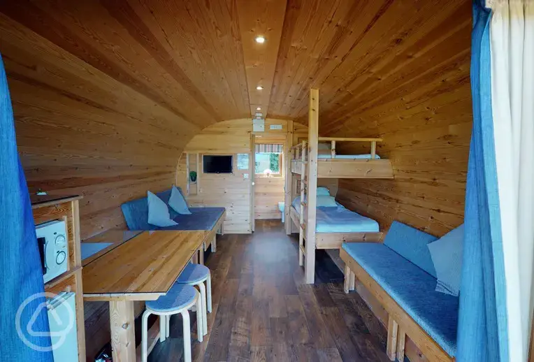 Super deluxe pod interior with bunk beds, single bed and a pull out double bed