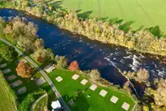 Aerial of the river view electric hardstanding pitches at Sleningford Watermill 