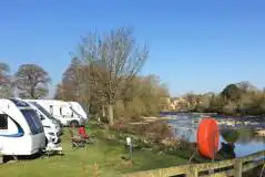 Premium electric riverside hardstanding pitches facing onto the River Urs