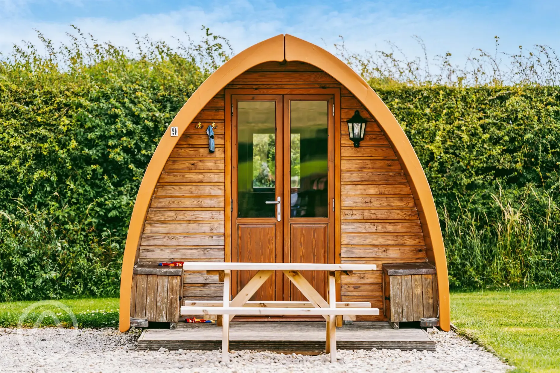 Camping pod exterior with outdoor seating