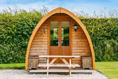 Camping pod exterior with outdoor seating