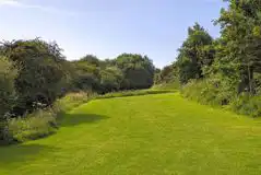 Grass pitches surrounded by countryside