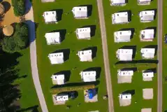 Bird's eye view of the hardstanding pitches with surrounding grass area Bird's eye view of the hardstanding pitches with surrounding grass area