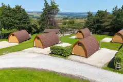 Aerial of the wooden camping pods with countryside views
