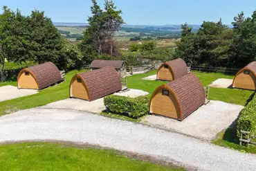 Aerial of the wooden camping pods with countryside views