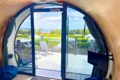 Super glamping pod with a glass front and decking with furniture