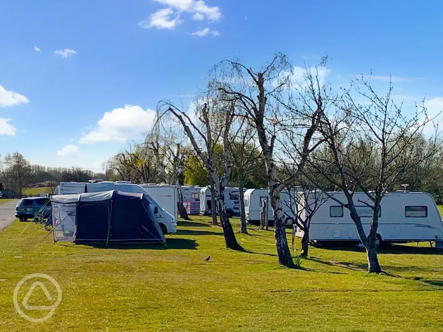 Caravans on grass pitches at Fairfields Farm with awning space