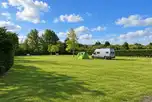 Electric grass pitches (The Paddocks) surrounded by trees