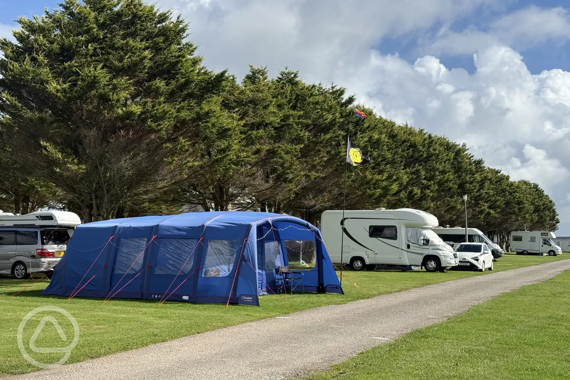 Grass camping pitches with a larger tent and motorhome