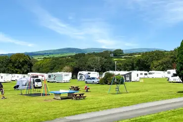 Grass pitches with optional electric at Pennymoor Caravan and Camping Park