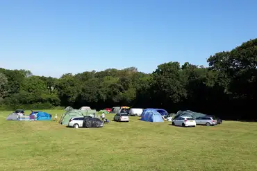 Grass pitches with space for a parked car