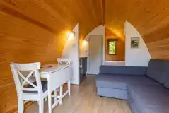 Mega pod interior with a futon sofa, TV, dining area, and ensuite toilet Mega pod interior with a futon sofa, TV, dining area, and ensuite toilet