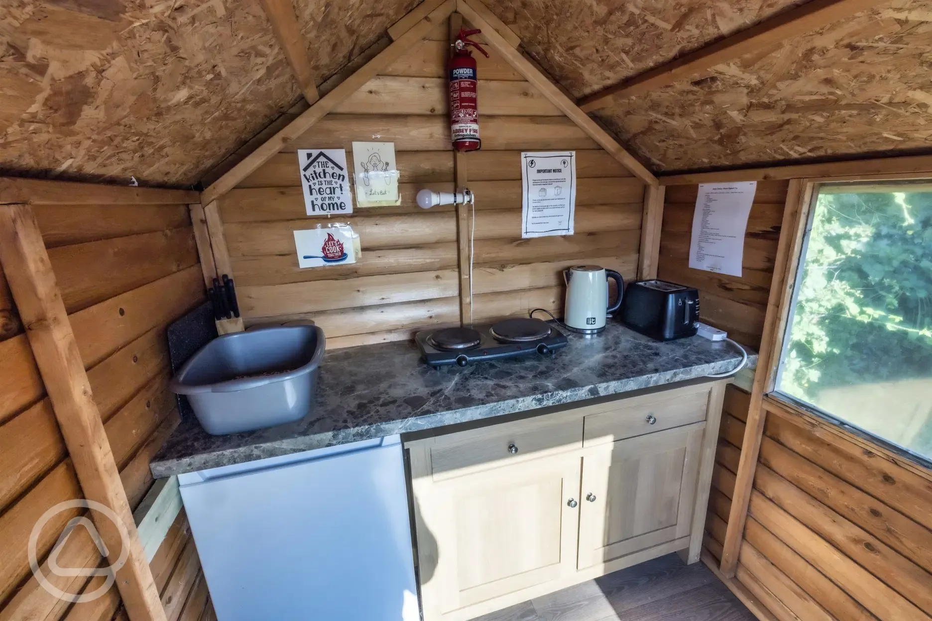 Blue shepherd's hut kitchen area