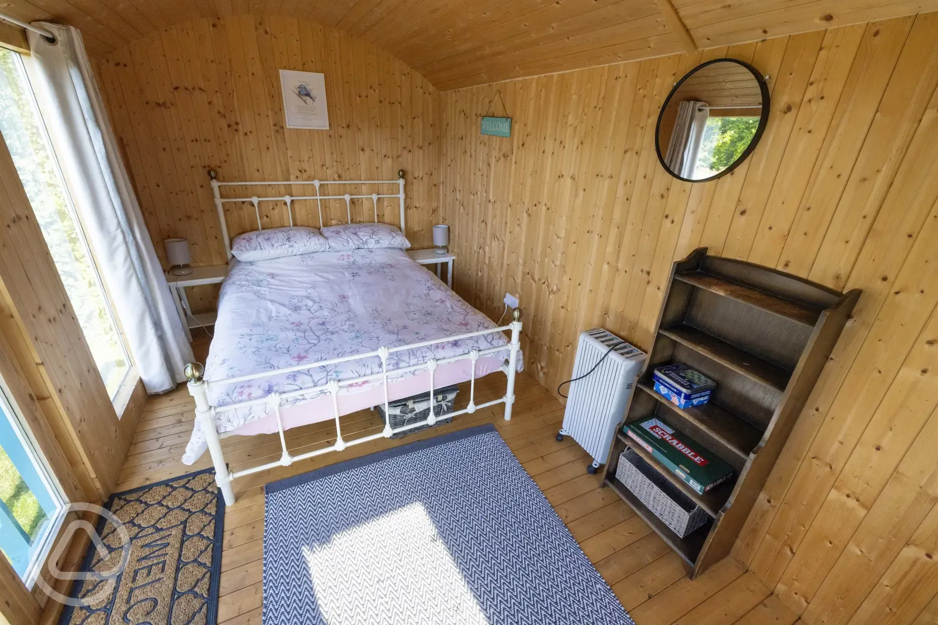 Blue shepherd's hut interior with double bed