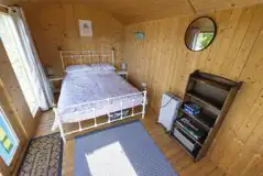 Blue shepherd's hut interior with double bed