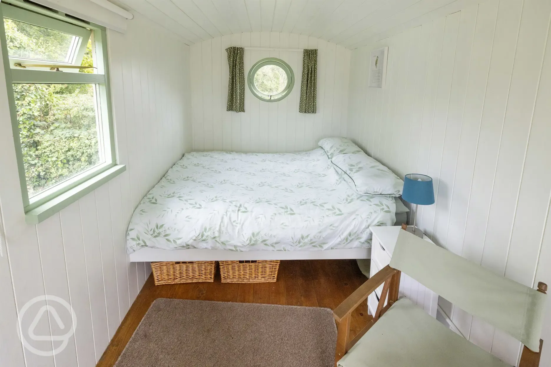 Green shepherd's hut bedroom area