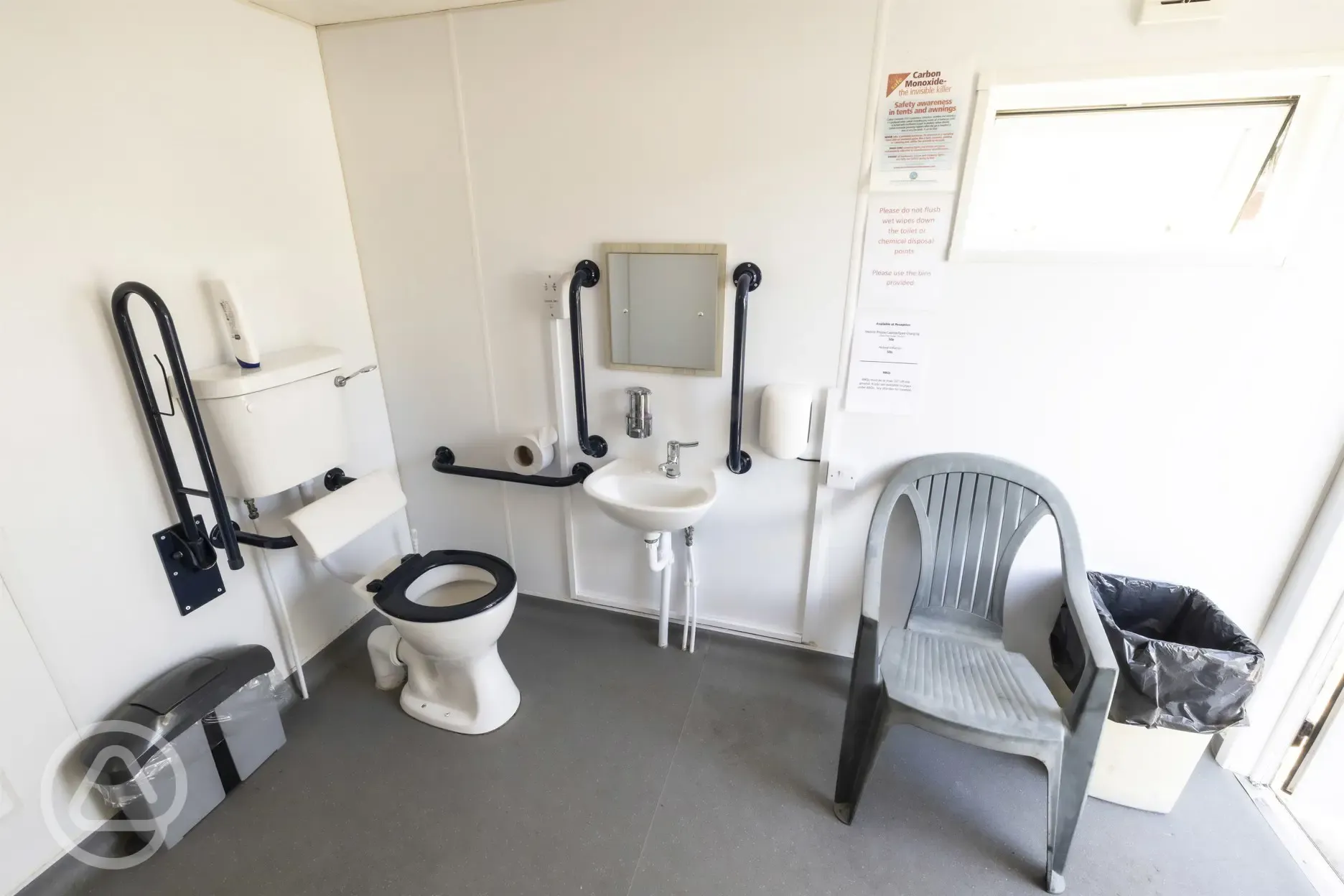 Disabled access bathroom with chair and handrail