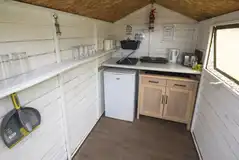 Green shepherd's hut kitchen area