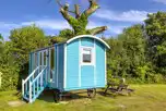 Blue shepherd's hut, sleeping two with a double bed, kitchen and electricity
