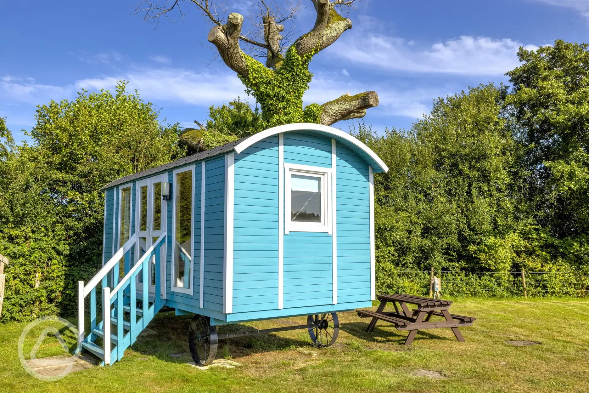 Blue shepherd's hut, sleeping two with a double bed, kitchen and electricity