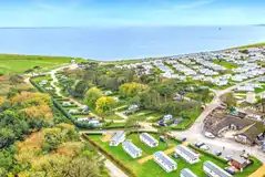 Aerial of the shop, restaurant and Abbeyfield pitches towards the coast