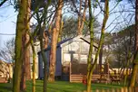 Skylight glamping cabins with glass fronts and decking areas