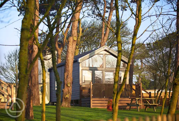 Skylight glamping cabins with glass fronts and decking areas