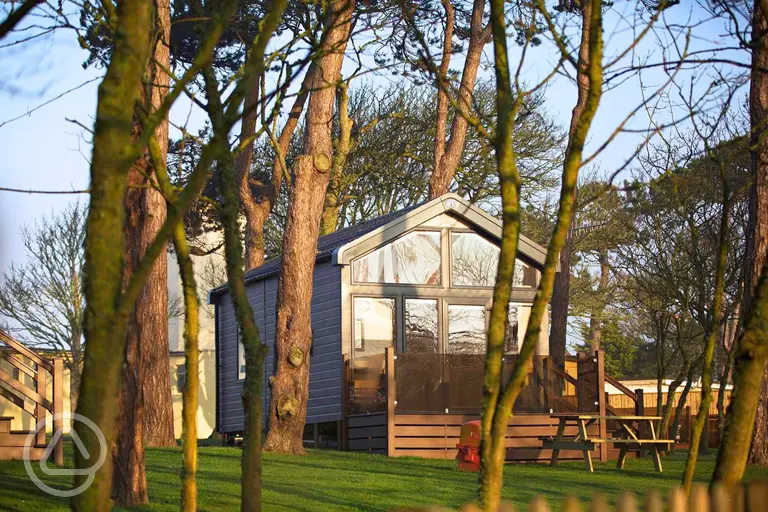 Skylight glamping cabins with glass fronts and decking areas