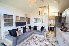 Skylight open-plan interior with a sofa bed, kitchen and mezzanine area