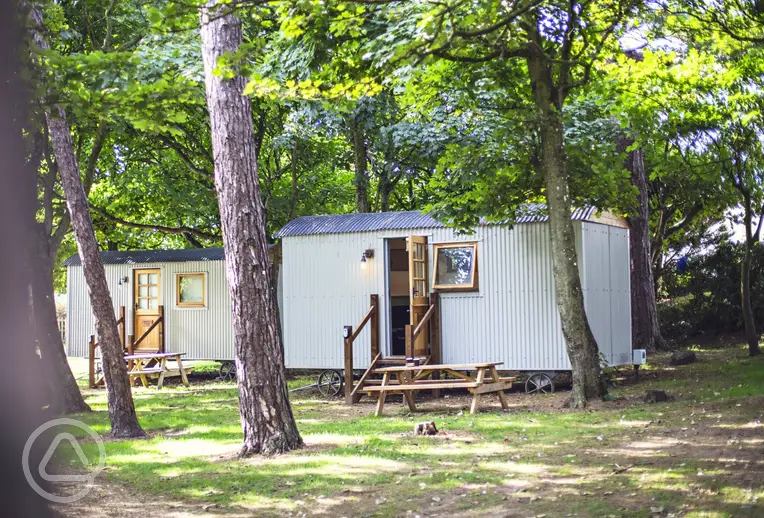Shepherd's huts (in the Rookery area) under the shade of trees