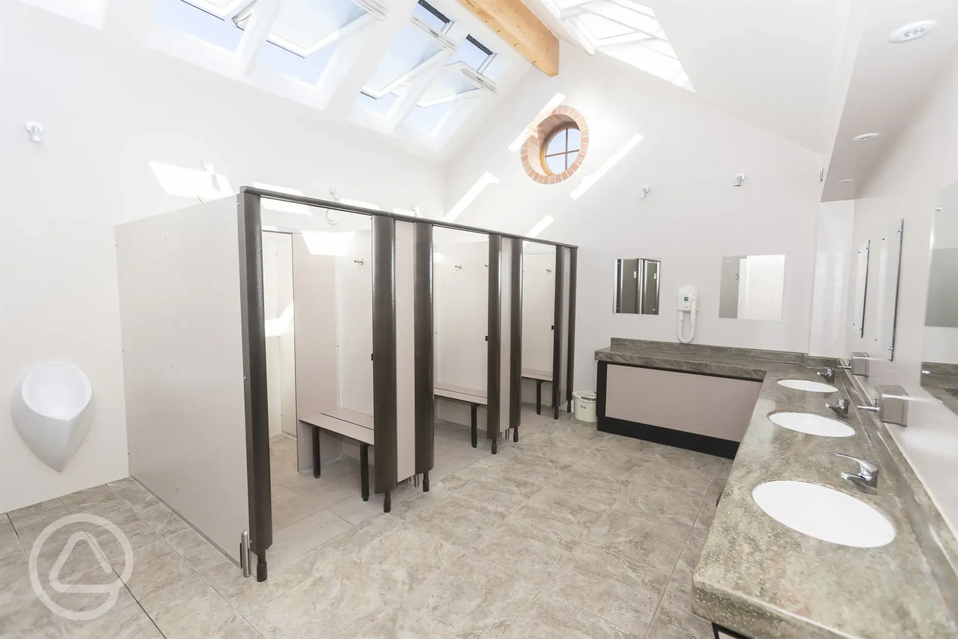 Showers with urinals, sinks and mirrors
